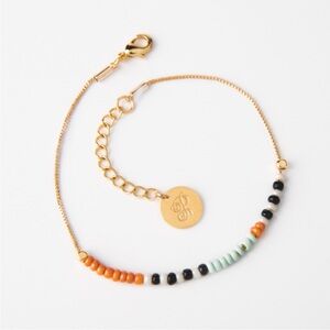 🆕 Gold Beaded Bracelet with Black and Orange Accents